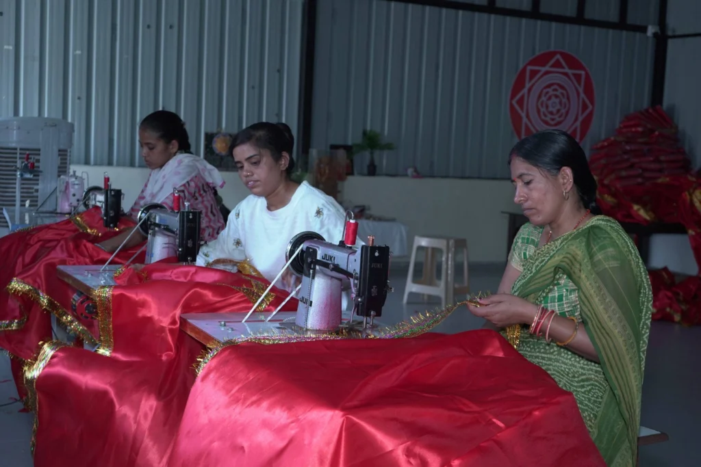 Women artisans at SSSK empowerment centre displaying handmade products together