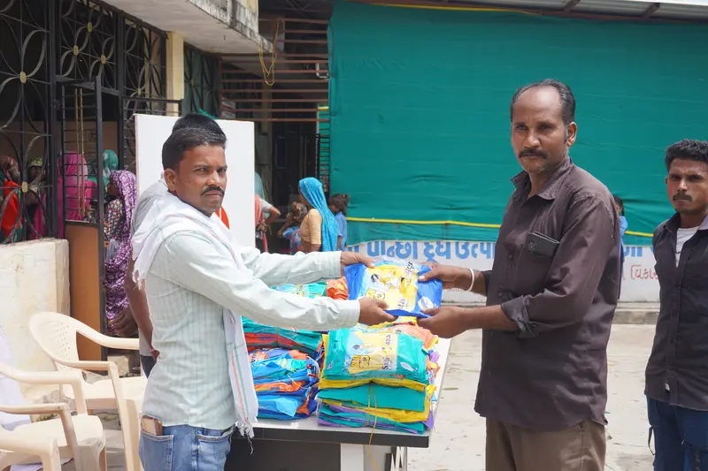 Community interaction during SSSK raincoat distribution in Pancha Village Ambaji