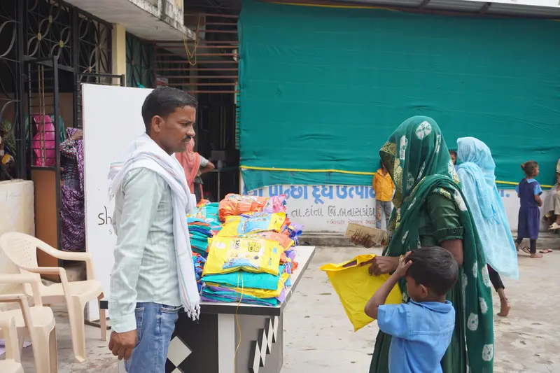 SSSK volunteers helping tribal members during raincoat distribution Pancha Village